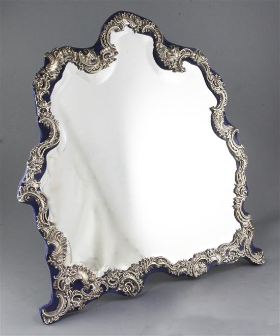 A large George V repousse silver mounted dressing table easel mirror height 24”/610mm width 21 ¾”/552mm.